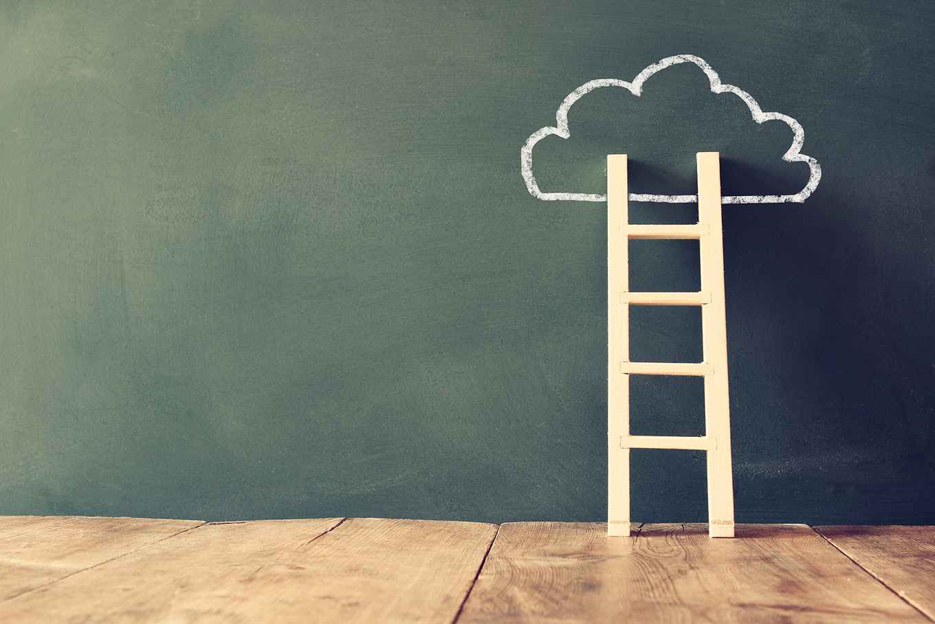 Ladder against schoolboard, on which a small cloud is drawn
